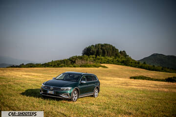 Volkswagen Passat Alltrack – front three-quarter, dark green in a grassy field