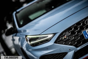 Hyundai i30N – front three-quarter, light blue with distinctive mesh grille