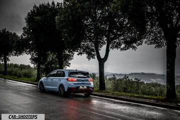 Hyundai i30N – rear three-quarter, white on a wet country road
