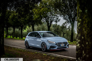 Hyundai i30N – front three-quarter, light blue on a country road