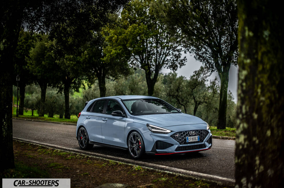 Hyundai i30N – front three-quarter, light blue on a country road
