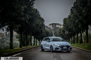 Hyundai i30N – front three-quarter, light blue on a tree lined road