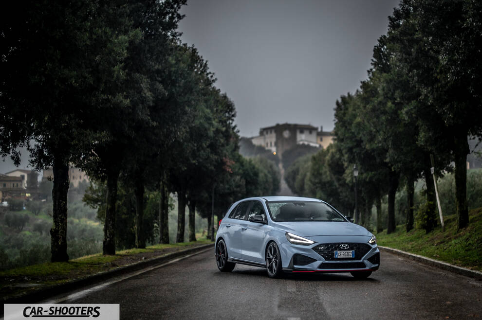 Hyundai i30N – front three-quarter, light blue on a tree lined road