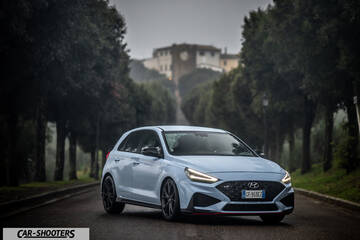 Hyundai i30N – front three-quarter, light blue on a tree lined road