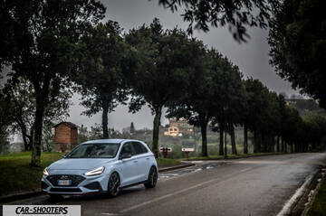 Hyundai i30N – front three-quarter, light blue on a country road
