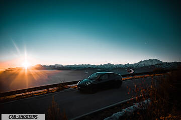 Tesla Model Y – front three-quarter, black against a mountain backdrop
