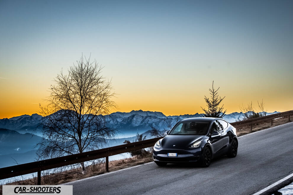 Tesla Model Y – front three-quarter, black against a mountain backdrop