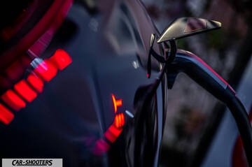 Tesla Model Y – detail, charging port and side mirror close-up