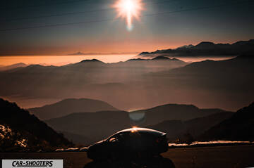 Tesla Model Y – side profile, against a mountain backdrop
