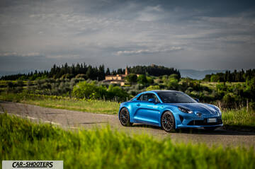 Alpine A110 – front three-quarter, blue on a country road
