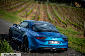 Alpine A110 – rear three-quarter, blue on a country road