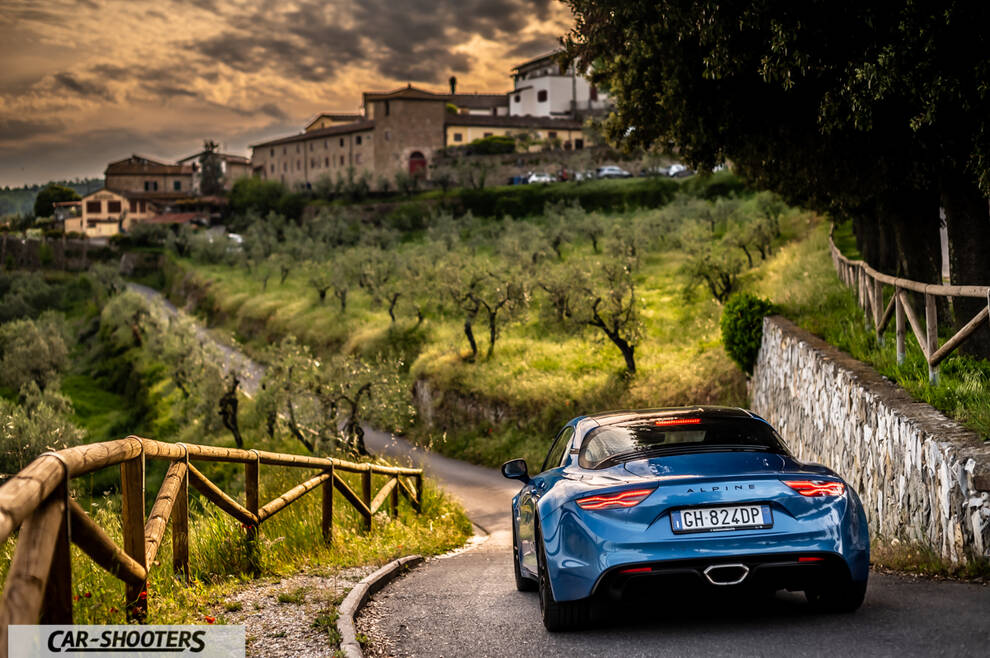 Alpine A110 – rear three-quarter, blue on a country road