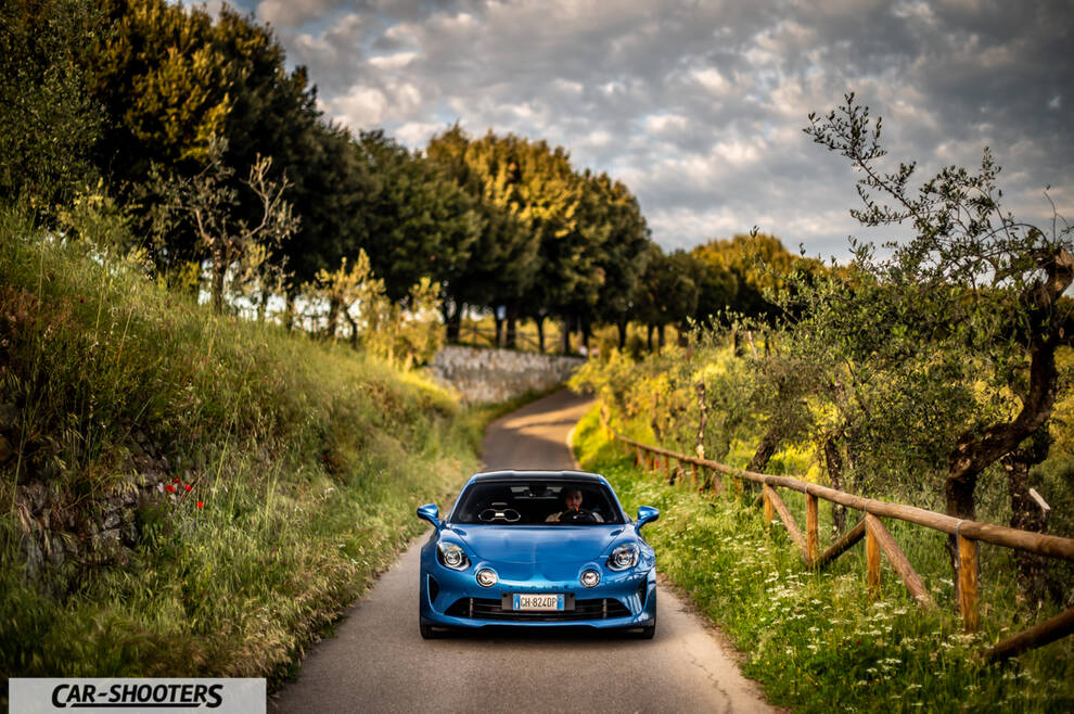Alpine A110 – front three-quarter, blue on a country road