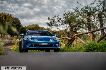 Alpine A110 – front three-quarter, blue metallic on a country road