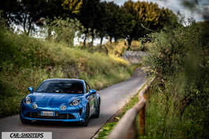 Alpine A110 – front three-quarter, blue on a country road
