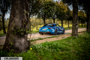 Alpine A110 – rear three-quarter, blue on a country road