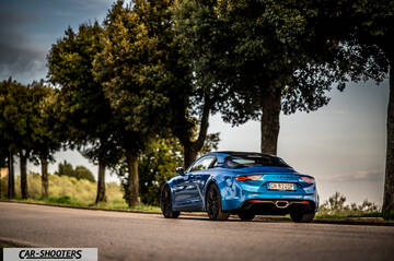 Alpine A110 – rear three-quarter, blue on a country road