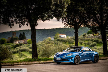 Alpine A110 – front three-quarter, blue on a country road