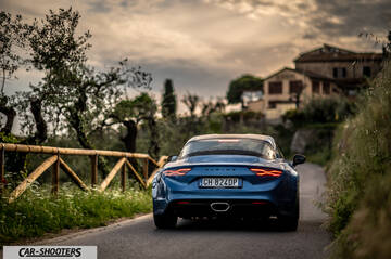 Alpine A110 – rear view, blue metallic on a country road