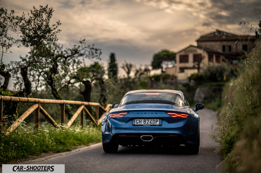 Alpine A110 – rear view, blue metallic on a country road