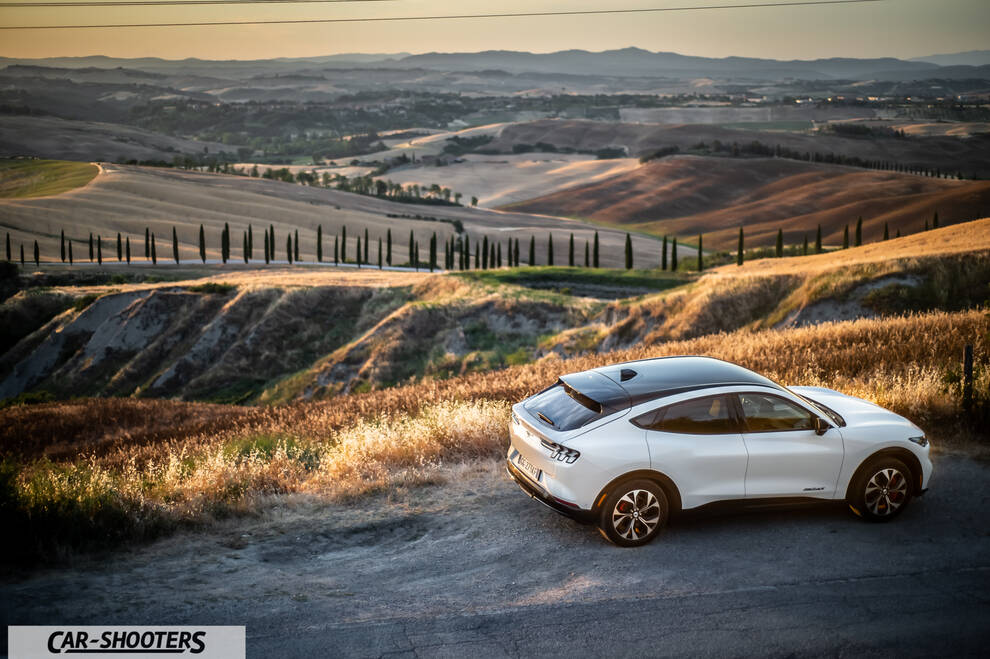 Ford Mustang Mach E – rear three-quarter, white against a mountain backdrop