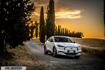 Ford Mustang Mach E – front three-quarter, white on a country road at sunset