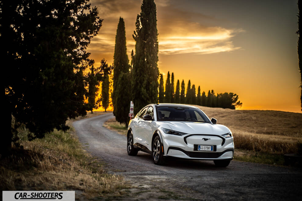 Ford Mustang Mach E – front three-quarter, white on a country road at sunset