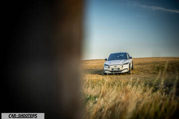 Ford Mustang Mach E – front three-quarter, white in a field