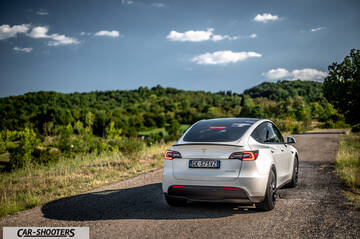 Tesla Model Y Performance – rear three-quarter, white on a country road