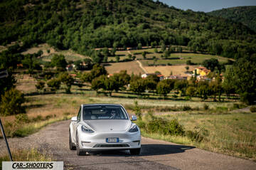 Tesla Model Y Performance – front three-quarter, white on a country road