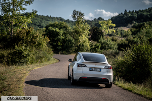 Tesla Model Y Performance – rear view, white on a country road