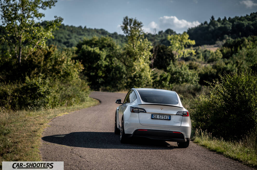 Tesla Model Y Performance – rear view, white on a country road