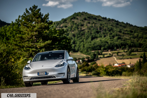Tesla Model Y Performance – front three-quarter, white on a country road