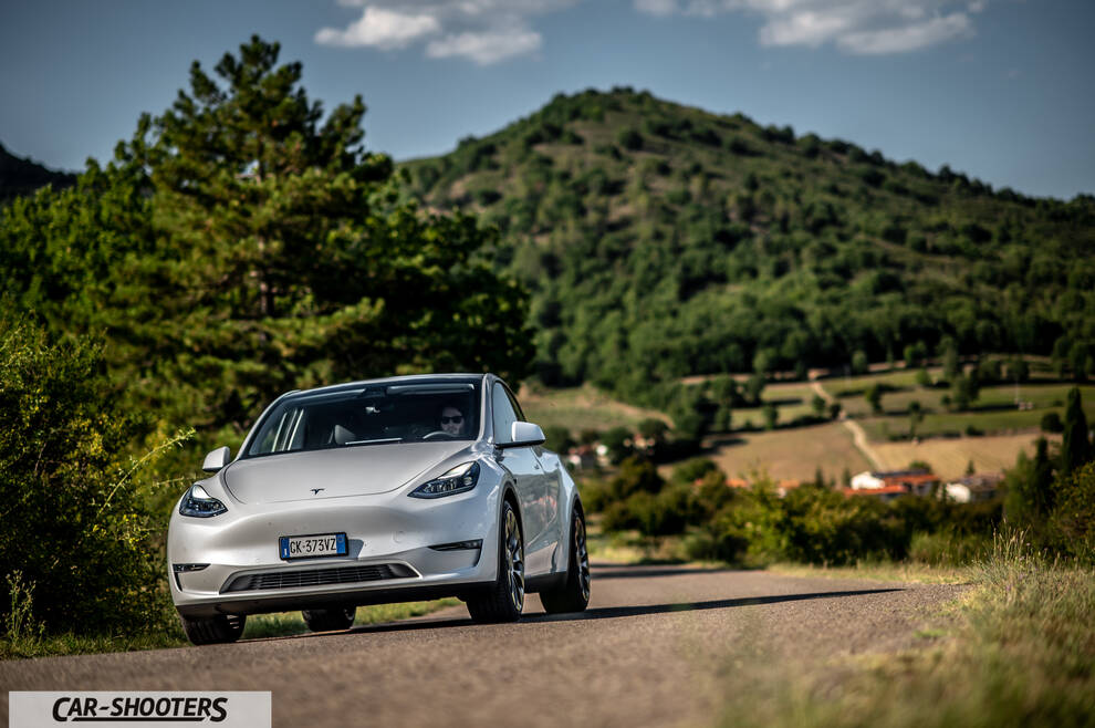 Tesla Model Y Performance – front three-quarter, white on a country road
