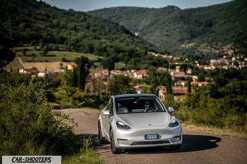 Tesla Model Y Performance – front three-quarter, silver against a mountain backdrop