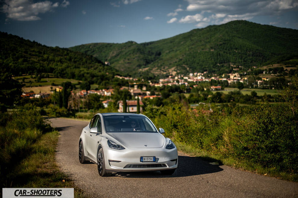 Tesla Model Y Performance – front three-quarter, silver against a mountain backdrop