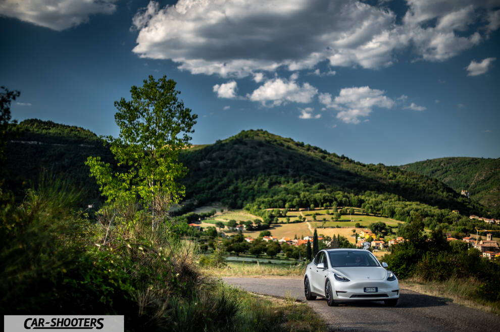 Tesla Model Y Performance – front three-quarter, white on a country road