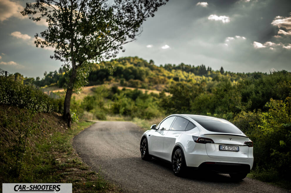 Tesla Model Y Performance – rear three-quarter, white on a country road