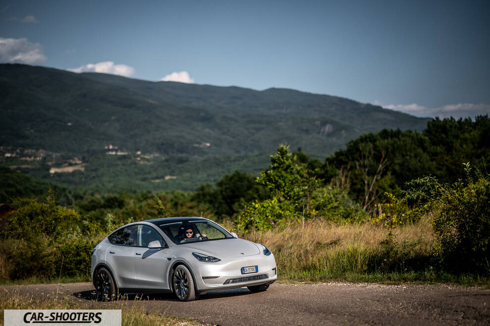 Tesla Model Y Performance – front three-quarter, silver against a mountain backdrop