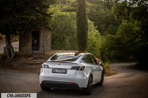 Tesla Model Y Performance – rear three-quarter, white on a country road