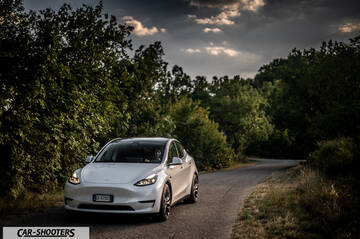 Tesla Model Y Performance – front three-quarter, white on a country road