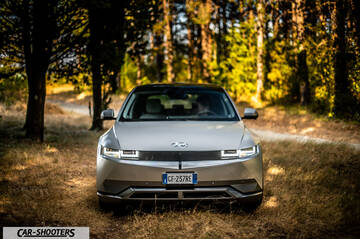 Hyundai Ioniq 5 – front three-quarter, silver in a wooded area