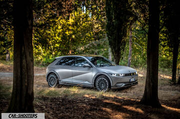 Hyundai Ioniq 5 – front three-quarter, matte grey in a forest