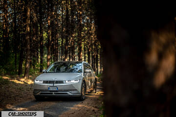Hyundai Ioniq 5 – front three-quarter, silver in a dense pine forest