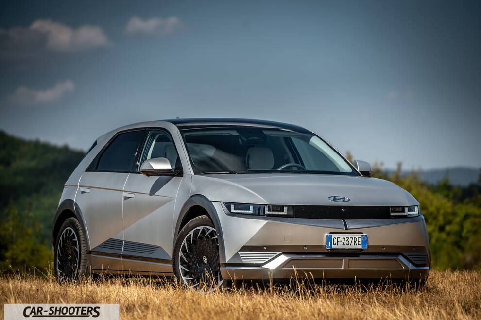 Hyundai Ioniq 5 – front three-quarter, silver in a grassy field
