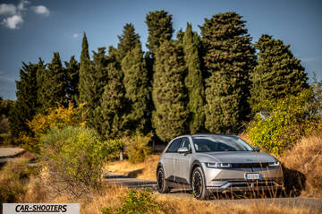 Hyundai Ioniq 5 – front three-quarter, silver against a tree backdrop