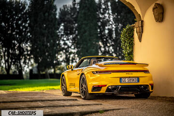 Porsche 911 Turbo Cabrio – rear three-quarter, yellow parked near a building