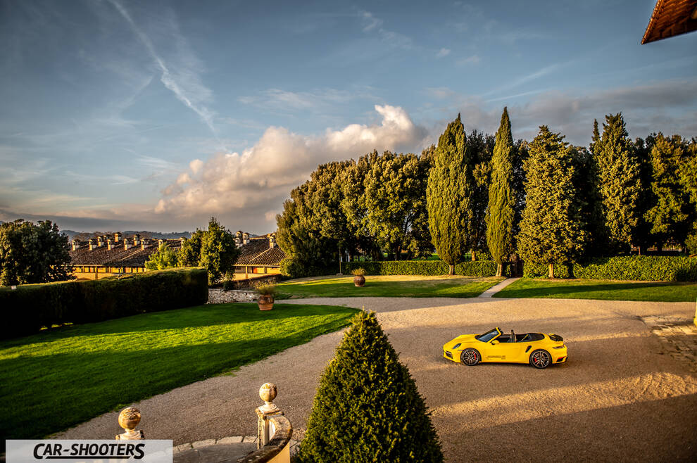 Porsche 911 Turbo Cabrio – side profile, yellow on a gravel courtyard