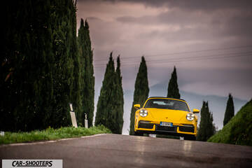 Porsche 911 Turbo Cabrio – front three-quarter, yellow on a country road
