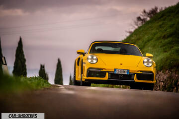 Porsche 911 Turbo Cabrio – front three-quarter, yellow on a country road